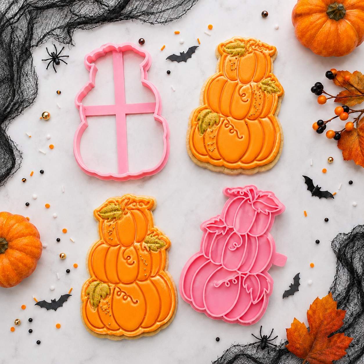 Halloween-themed cookies with pumpkin designs and cookie cutters on a decorative background.