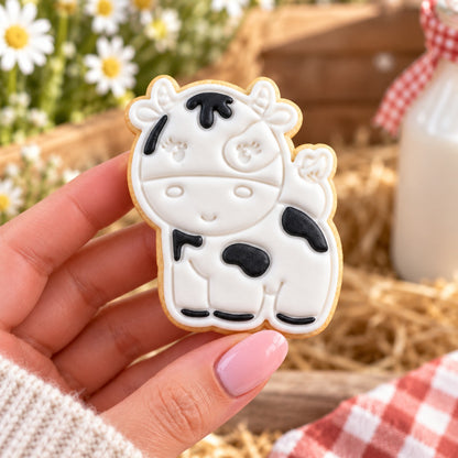 Cow Farm Yard Cookie Cutter and Stamp - decorated cookie held in hand